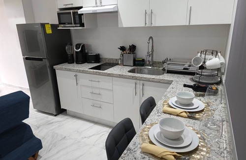 Playa del Carmen Apartment | Modern vacation apartment with gym, jacuzzi, rooftop pool and sauna.