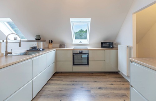 Breklum Apartment | Modern vacation apartment Heimathafen with balcony and garden view in the village of Breklum