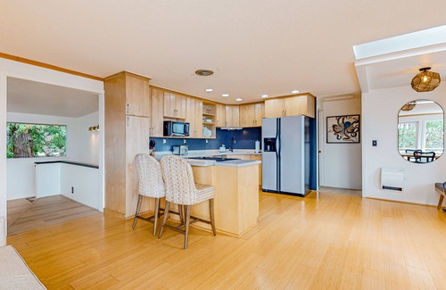 Adelma Beach House | Modern water view retreat with foosball table, expansive deck, and gas fireplace