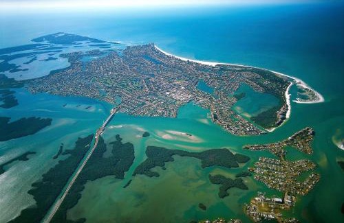 Naples House | Modern waterfront home in Artesia with pool/gym