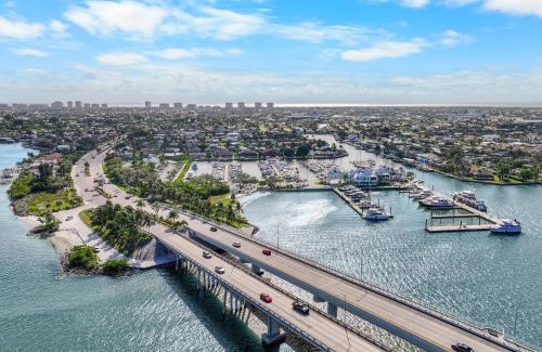 Naples House | Modern waterfront home in Artesia with pool/gym