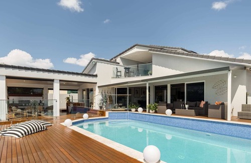 Runaway Bay House | Modern Waterfront Retreat| Private Pool & Dock