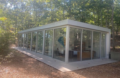Water Mill House | Modernist Glass House nestled in tall pines and nature offering total privacy