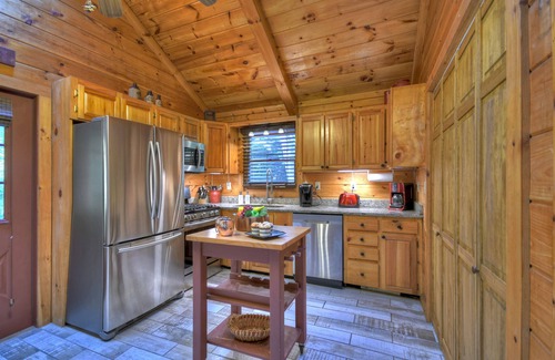 McCaysville Cabin | Nestled by the babbling creek, Creekside Hideaway warmly welcomes pets, offering a hot tub, over-sized screened porch with TV, firepit, and WiFi