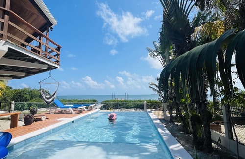 Caye Caulker Villa | OCEANFRONT ECO-CHIC HOME WITH INFINITY POOL, DOCK, AIR CONDITIONER & TV