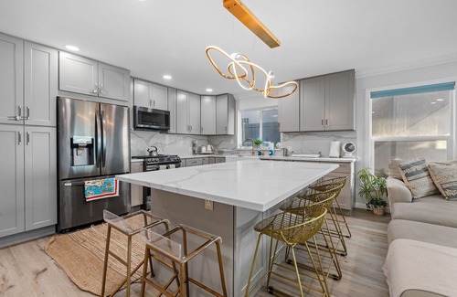 Alamitos Beach House | Oceanfront retreat with rooftop deck, modern interior, marble finishes, & W/D