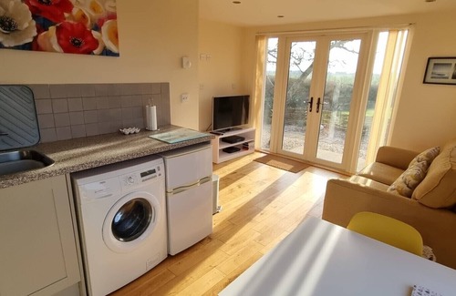 Alburgh House | One bedroom barn with open plan living area, private patio/garden,great sunsets