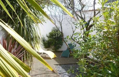 La Baule-Escoublac Apartment | Pop design apartment, renewed in 2008, terraces in the garden, heart of La Baule