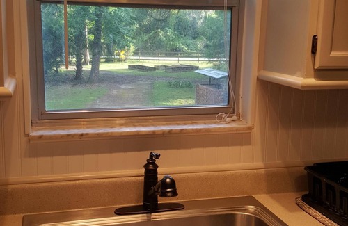 Floral City House | Quaint Cabin Retreat on a wooded fenced acre with a canal to the river