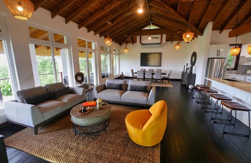 Gibson Bight House | Relax at this hillside retreat that overlooks the lush forest and the Caribbean.