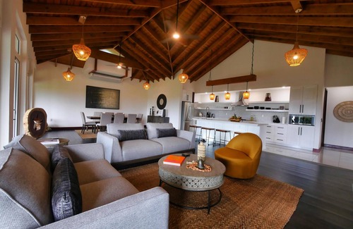 Gibson Bight House | Relax at this hillside retreat that overlooks the lush forest and the Caribbean.