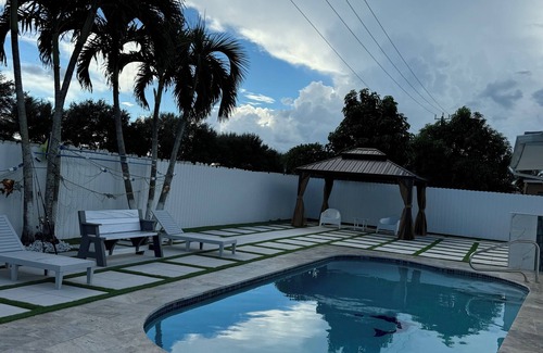 Royal Palm Beach House | Remodeled cozy family house with heated pool, 10 min from the airport!