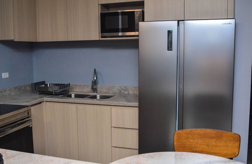Eden Gardens Apartment | Resort like accommodations in Kingston with WiFi, AC, Pool and Rooftop. King bed
