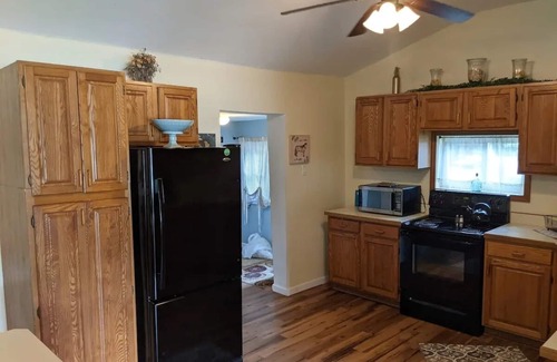 Colton Cottage | Riverfront Cottage with Hot Tub, Kayaks, Canoes, & Fishing Boats!