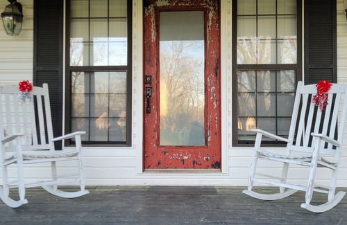 Peach County House | Rocking Chair front porch looking out on sprawling pecan trees filled w/nature.