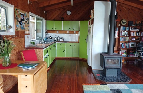 Bethells Beach House | Ruru Cottage nestled at beautiful Bethells Beach