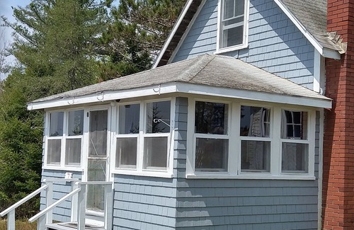 Dennysville Cottage | Rustic, two-story, clapboard cottage, field view, Pet-friendly, Downeast Maine