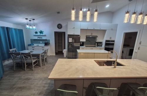 The Orchard House | Sadie's Daytona private pool home with 5 king beds , pool table and arcade games