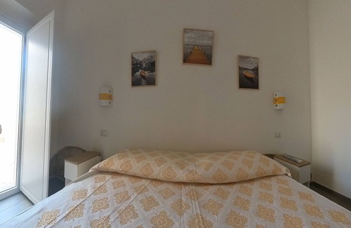 Sant'Antioco House | Sant Antioco Yellow Apartment with 2 Way Air Con