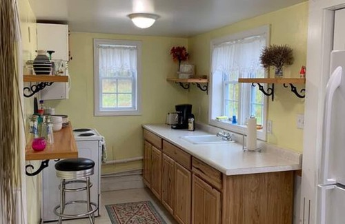Eastport House | Sea-Breeze Cottage perched on the edge of the bay.