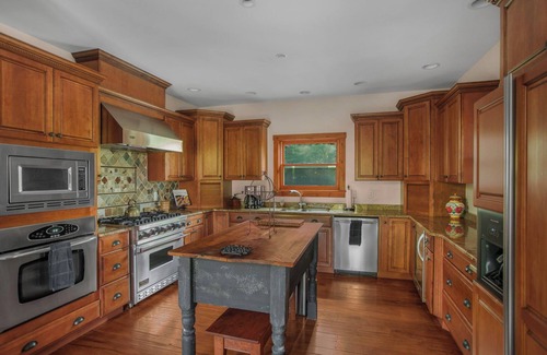Huntly House | Secluded 4 bedroom log style home with screened porches, deck and fishing pond.