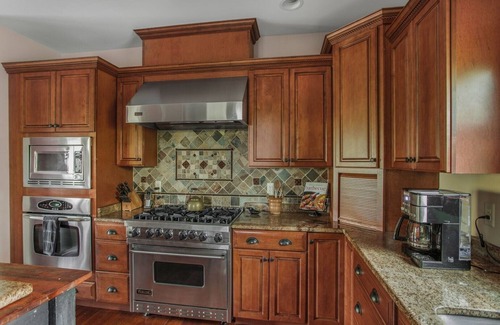 Huntly House | Secluded 4 bedroom log style home with screened porches, deck and fishing pond.