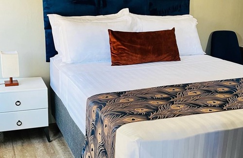 Gaborone Bed & Breakfast | Shiloh Inn-Tranquil midnight blue accent walls set relaxation tone for your stay
