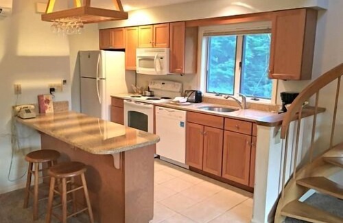 Bartlett Hotel | Spacious Two-Level Family Condominium Unit Featuring Full Kitchen, Private Balcony, Jetted Tub, and