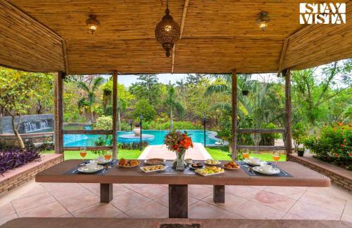 Sohna Villa | StayVista at Maple Farms with Pool, BBQ & Bonfire