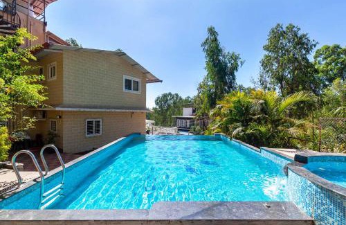 Nandanwan Villa | StayVista's Chimney Cottage with Sprawling Lawns, Picturesque Views, Plunge Pool, Jacuzzi, and Home Theatre