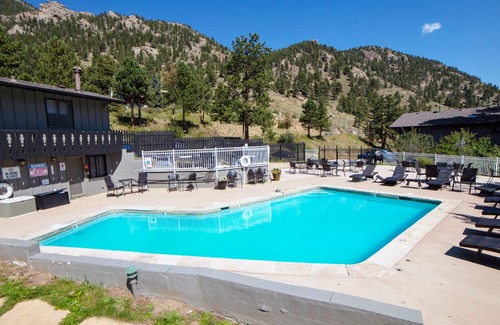 Estes Park Condo | Suite features King bed, full kitchen, and deck with a river view.