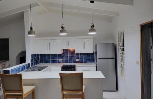 Dickenson Bay Apartment | Swimming Pool- Balcony Veranda- Sea & Sunset Views