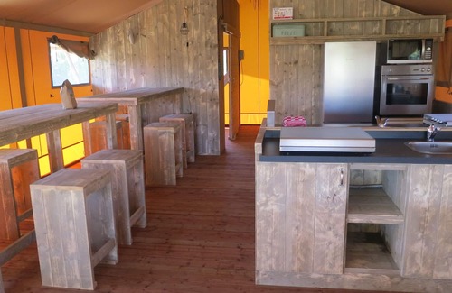 Bant House | Tents with kitchen and bathroom near a pond