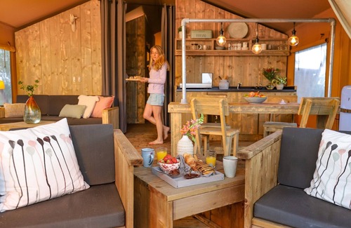 Bant House | Tents with kitchen and bathroom near a pond