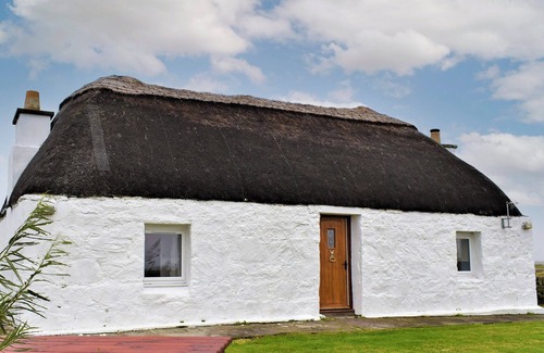 Benbecula Cottage | The cottage is so attractive with its traditional thatch and whitewashed walls.