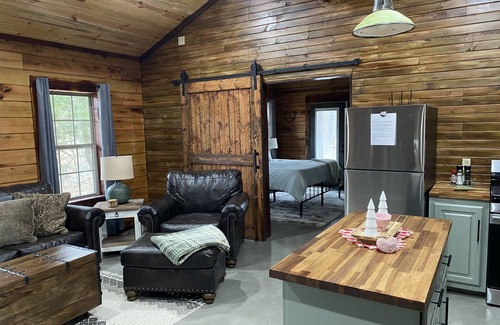 Tishomingo Cabin | The Cozy Pines is a newly built, romantic log cabin with a 2-sided fireplace.