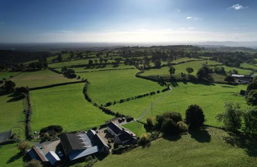 Oswestry House | The Nook at Pentregaer Ucha, with tennis court & lake.