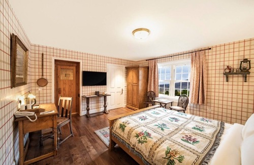 Shiel Bridge Bed & Breakfast | The wooden floors, vintage furniture, and tartan accents create a comfy room