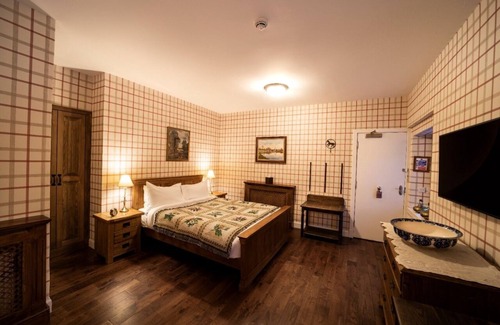Shiel Bridge Bed & Breakfast | The wooden floors, vintage furniture, and tartan accents create a comfy room