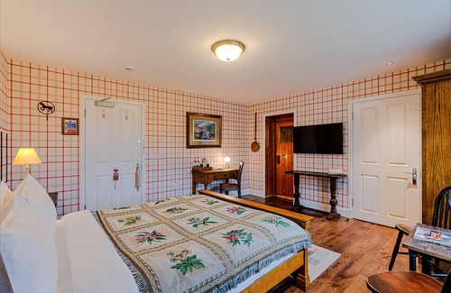 Shiel Bridge Bed & Breakfast | The wooden floors, vintage furniture, and tartan accents create a comfy room