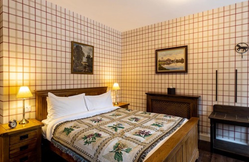 Shiel Bridge Bed & Breakfast | The wooden floors, vintage furniture, and tartan accents create a comfy room