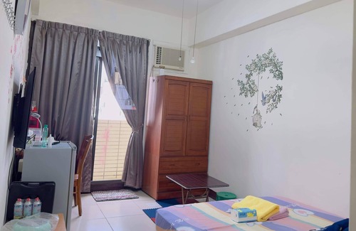Hukou Apartment | This room have its own private bathroom, bed, cabled tv, wardrobe and balcony.