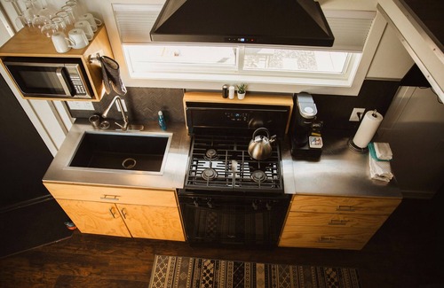 Meeker House | This Tiny Home is custom made by a Colorado craftsman has one Queen bed in loft accessible by stairs and also has a fold out Full futon on main level. Sleeps up to 4. Please note, this home does have a sleeping area in a loft. If you require an accom