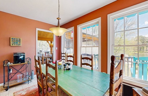 Bumpass House | Tranquil lakefront retreat with hot tub, screened porch, kayaks, and more