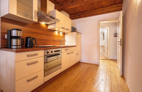 Altstadt Apartment | under a historical exposed wooden beam ceiling, monument protection