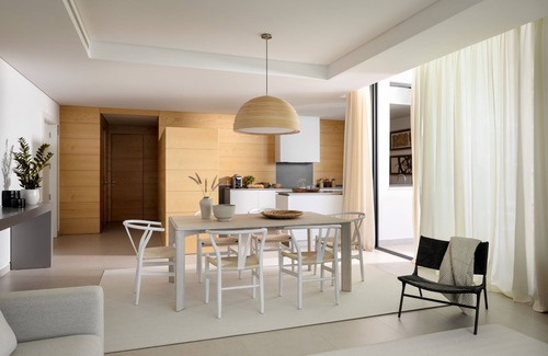 Vila Nova De Cacela Apartment | Unwind on the shaded terrace overlooking the lush gardens and pool.