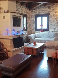 Kato Pedina House | Vargiani Stone Retreat with Fireplace & View