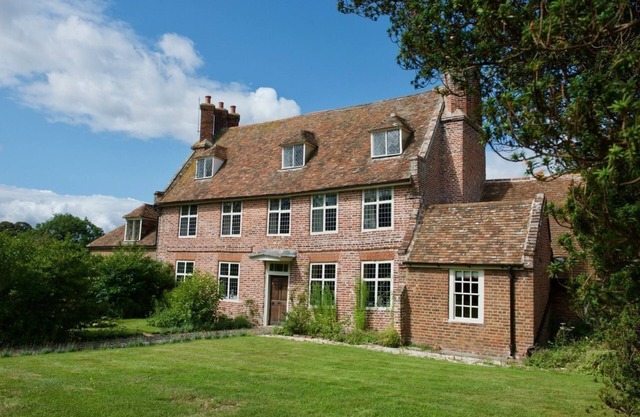 An exquisite Tudor Farmhouse lovingly restored with 7 bedrooms, 6 bath/shower, sleeping 14 in beauti