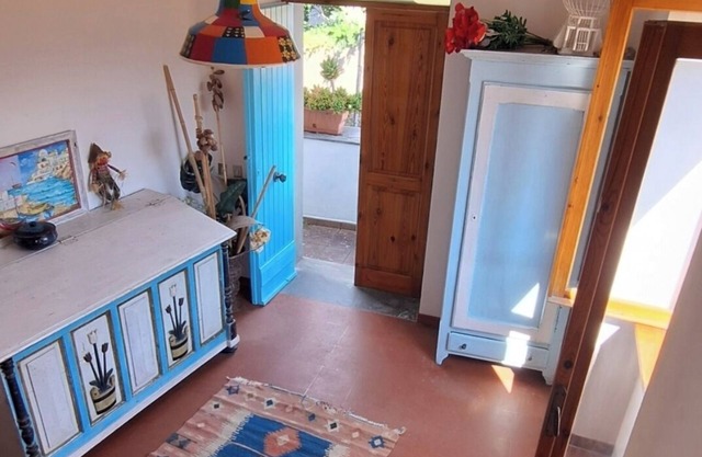 An oil mill renovated as a cottage located in a hamlet surrounded by greenery.