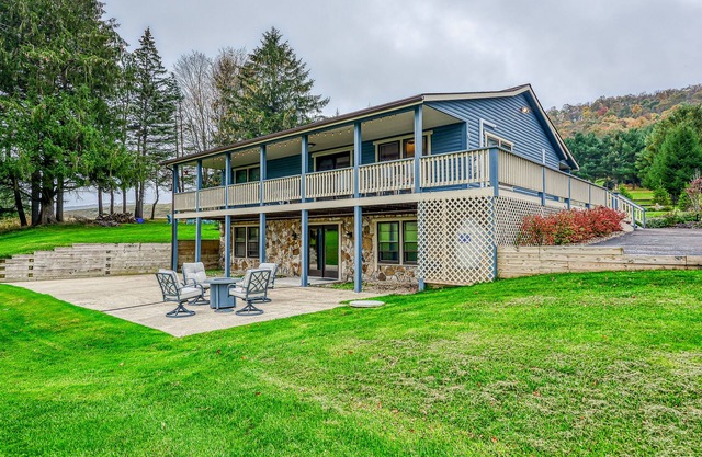 Dog-friendly home with private pond, wraparound porch & fireplaces